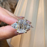 "Brenzy" Emerald Cut 2.5 Carat Three Stone Trilogy Engagement Ring life style-Front view