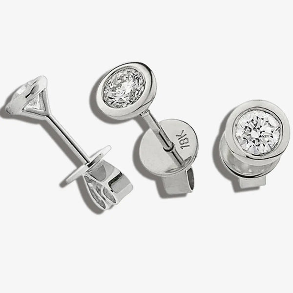 ROUND BRILLIANT SOLITAIRE EARRINGS IN RUB OVER SETTING 18K WHITE GOLD HEERA DIAMONDS
