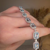 Emerald Shape 11 Carat Aquamarine Tennis Bracelet Featuring Diamond Halo BRHAEC